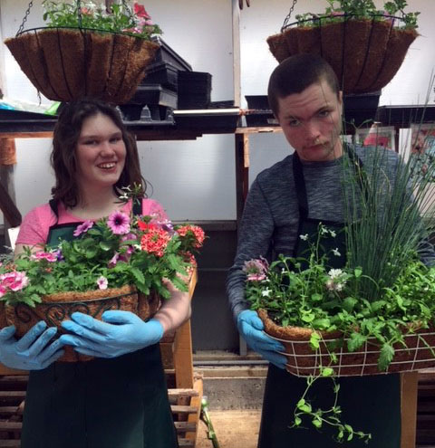WorkAbility students making flower baskets