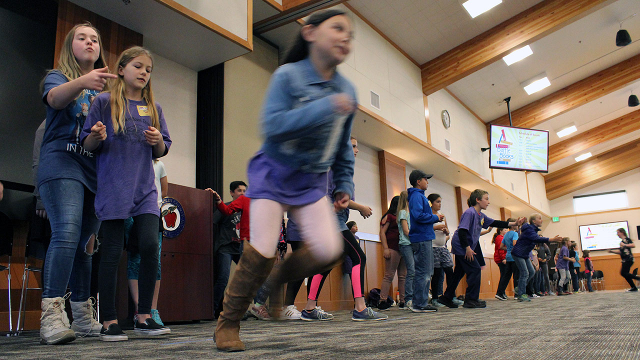 Students race across the room as part of a relay game at the Battle of the Books.