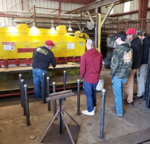 Eureka High metal shop students learn about the heavy machinery used in metal fabrication.