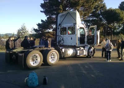 Students gather at the front of a truck to view the element of the truck