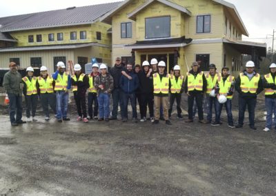 Students gather in front of construction site for a group photo