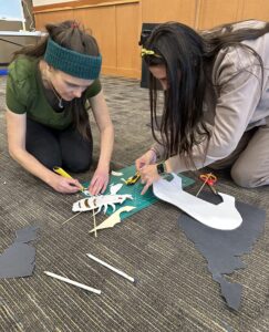 Photo of educators cutting paper for making shadow puppets
