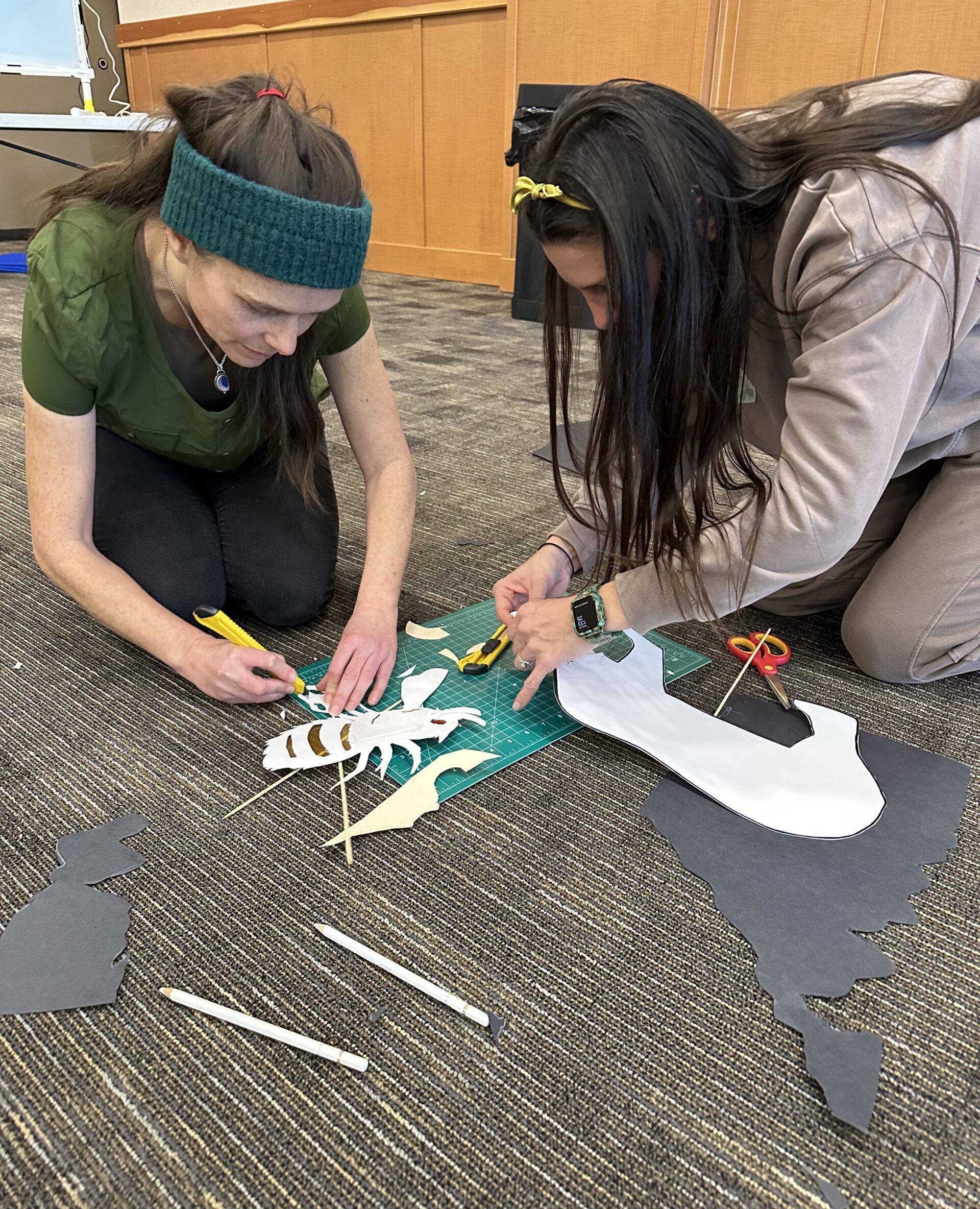 Photo of educators cutting paper for making shadow puppets