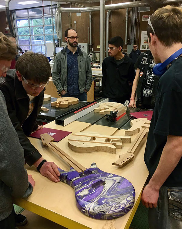 Students in wood shop with teacher