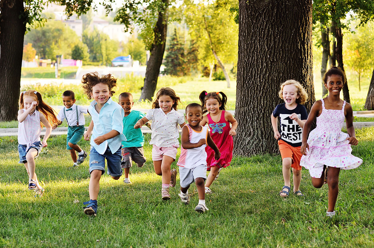 Preschool aged children running in the grass