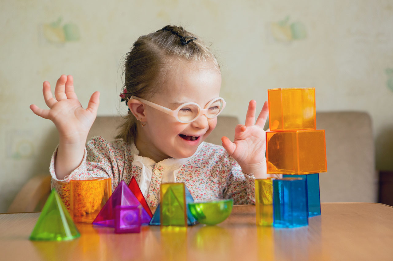 A young child playing with plastic blocks