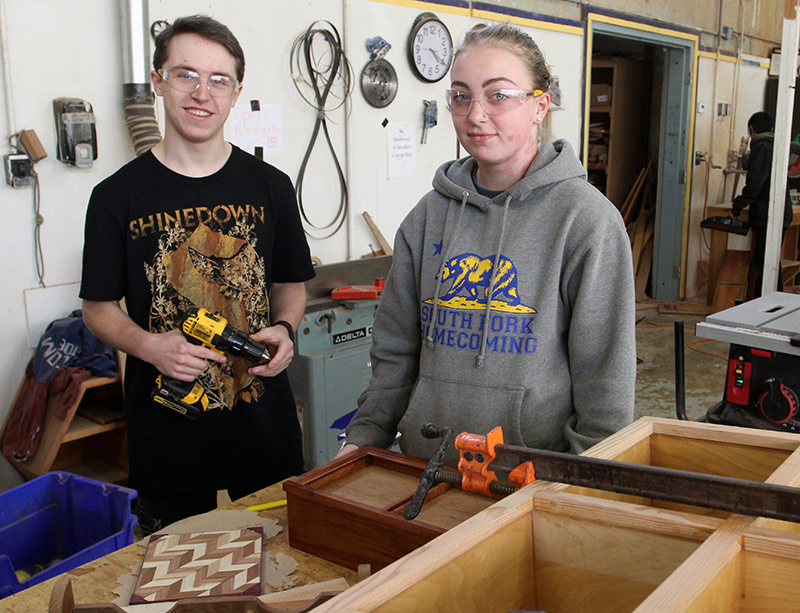Two students in a woodshop class