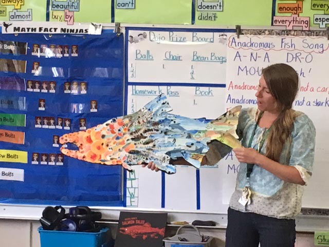 Teacher in a classroom with a fake fish