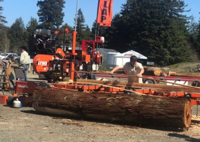 A giant log with heavy machinery to carry it