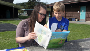 An ELP tutor works with a student.