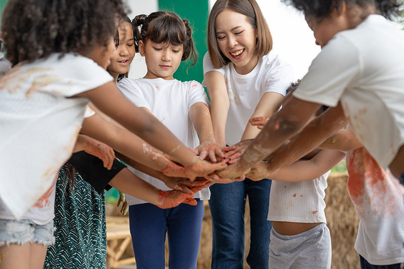 A teacher with several young students