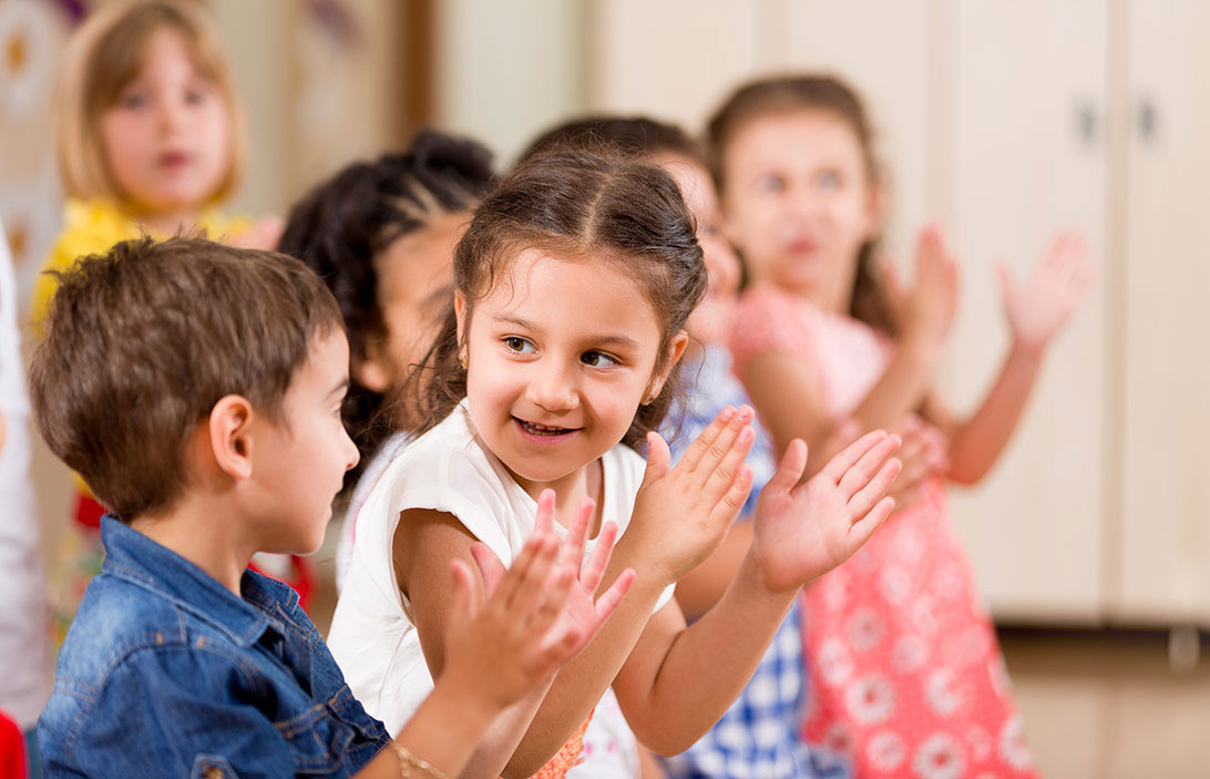 Children clapping in a classroom