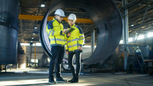 Photo of two people on construction site